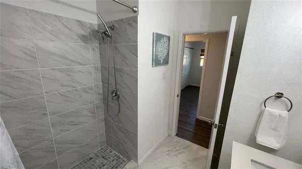 a bathroom with a shower and a mirror