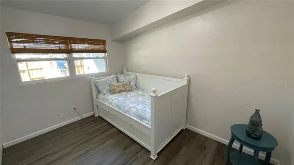 a living room with hard wood floors and a window
