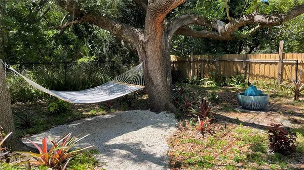 a view of a chair and table in the garden