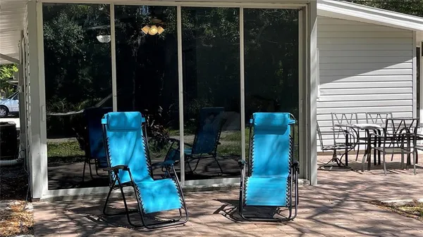 a view of a backyard with table and chairs and potted plants
