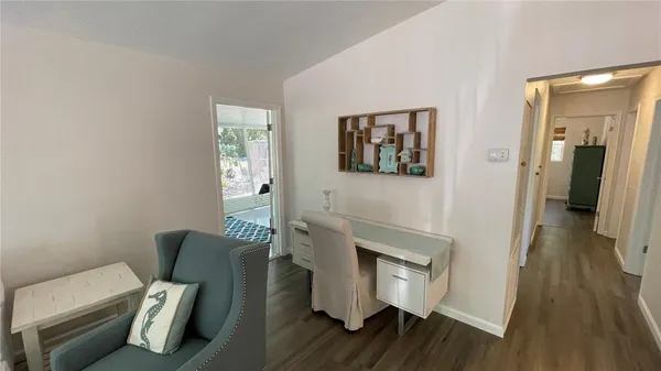 a view of living room with furniture and wooden floor