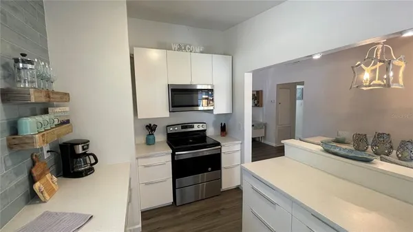 a kitchen with a sink appliances and cabinets