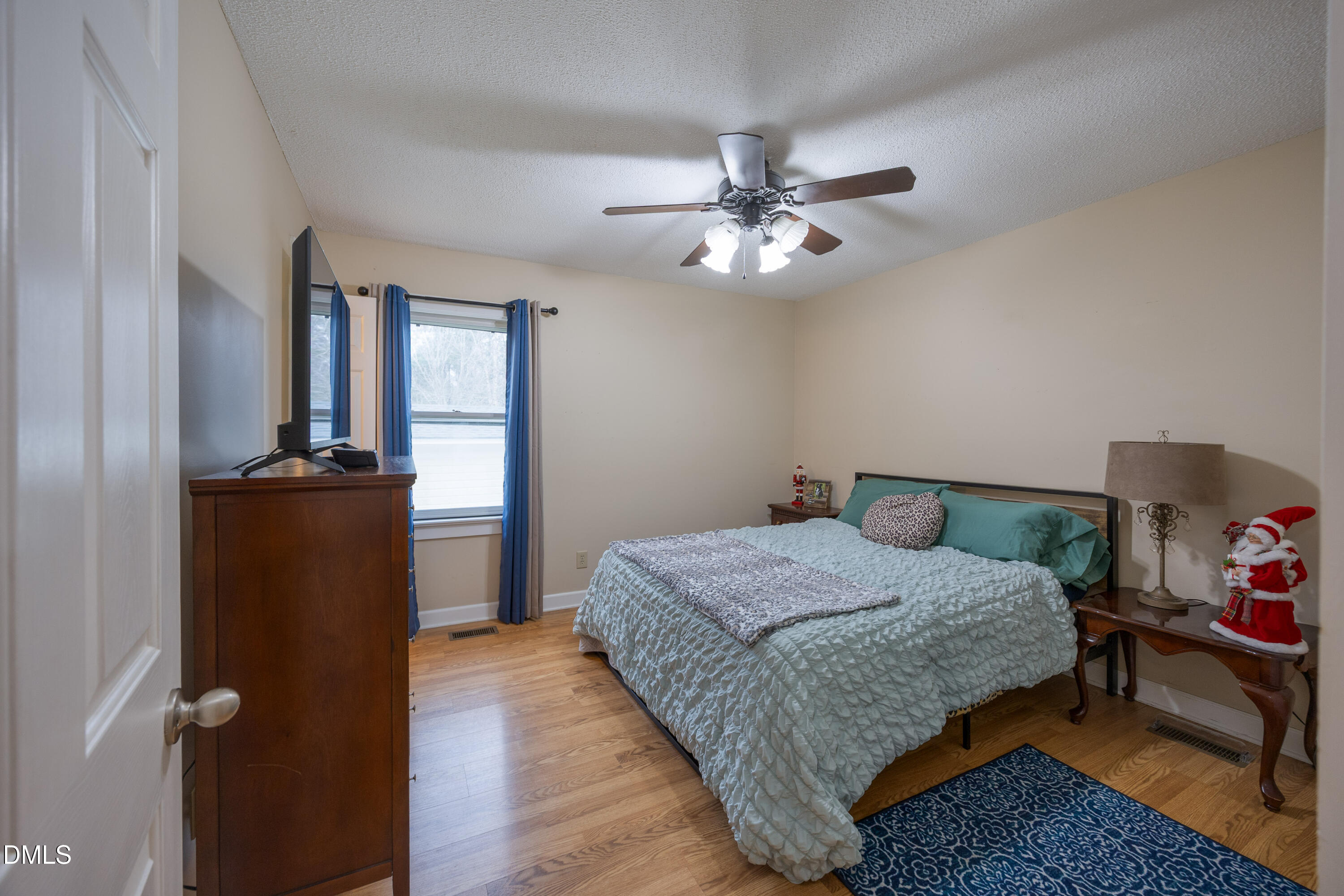 1854 Pope Road Dunn, NC 28334 - Photo 17 of 27 a bedroom with a bed and wooden floor