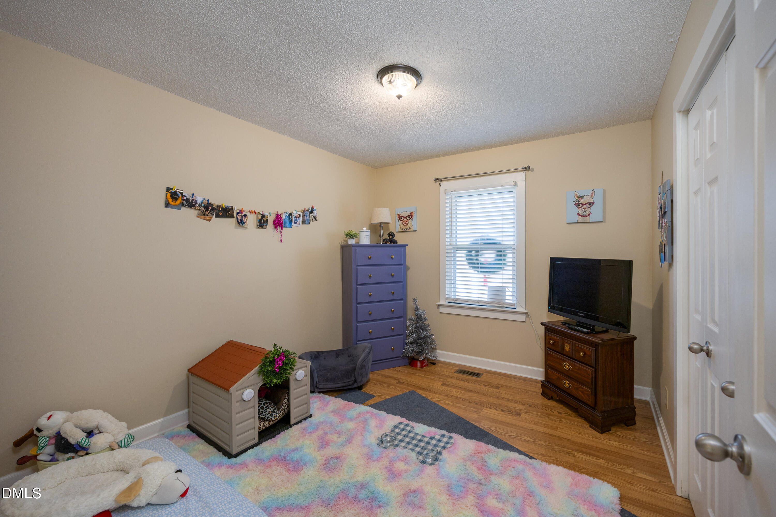 1854 Pope Road Dunn, NC 28334 - Photo 21 of 27 a bedroom with a bed and wooden floor