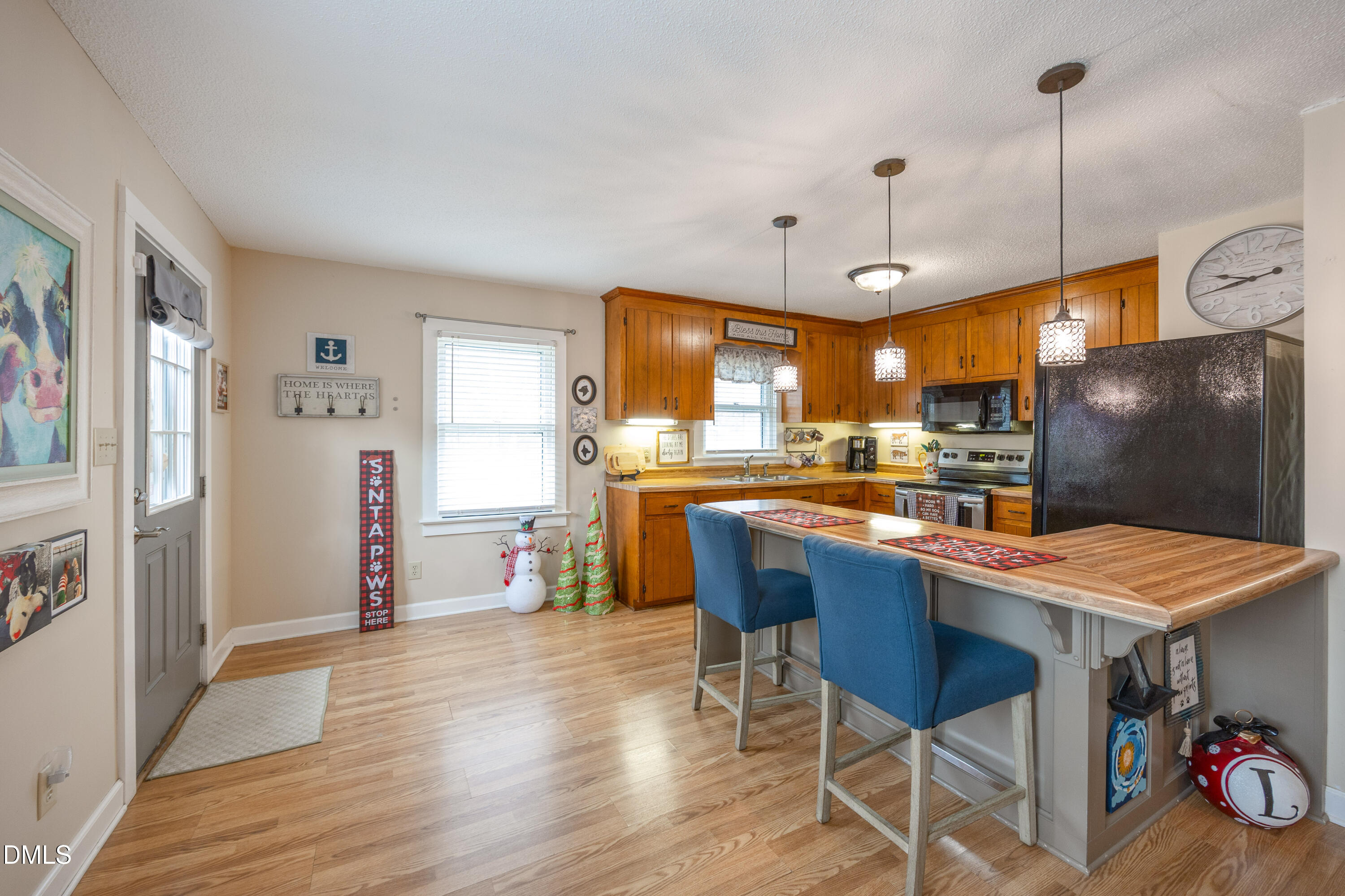 1854 Pope Road Dunn, NC 28334 - Photo 9 of 27 a kitchen with stainless steel appliances granite countertop a refrigerator a sink dishwasher a dining table and chairs with wooden floor