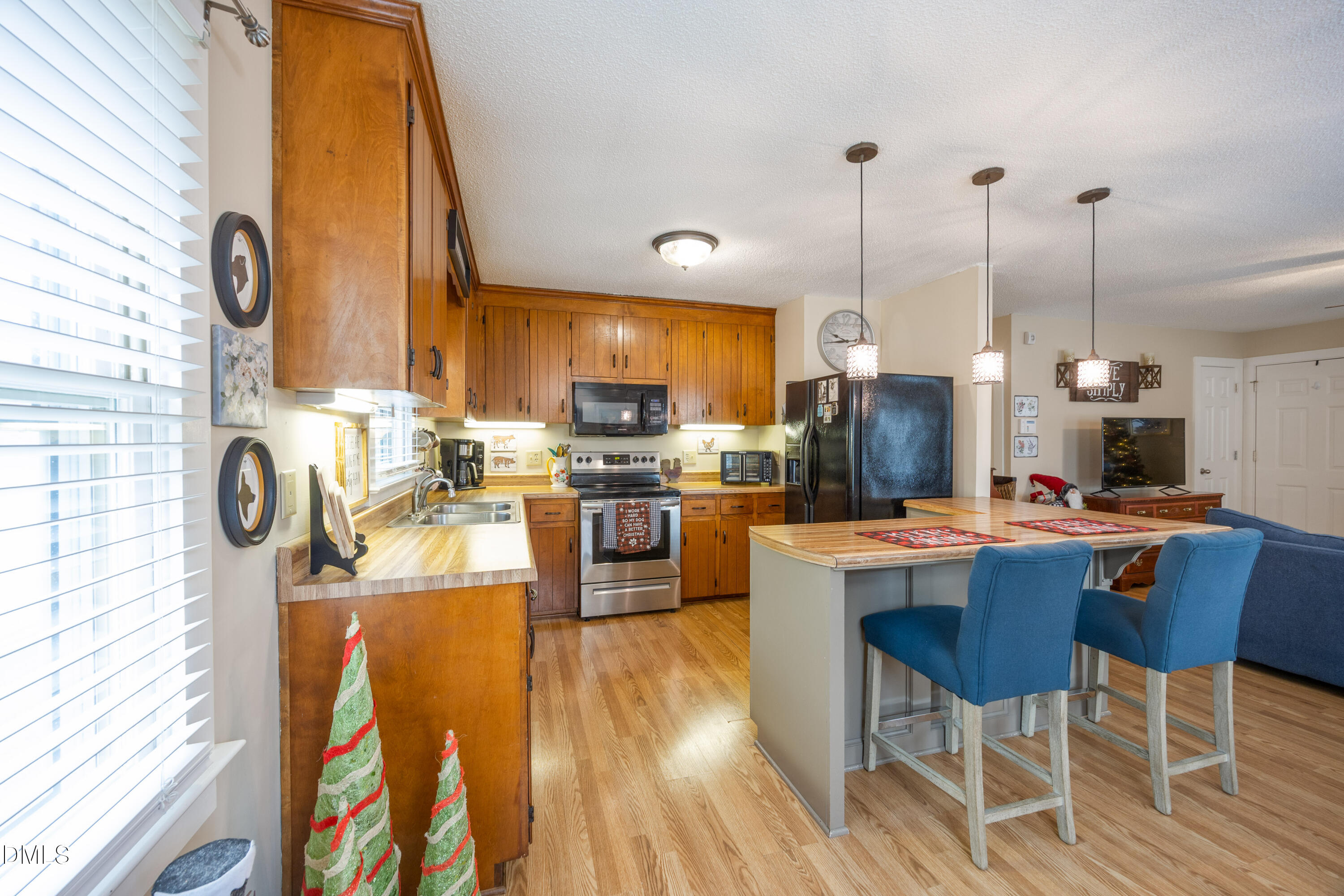 1854 Pope Road Dunn, NC 28334 - Photo 10 of 27 a kitchen with stainless steel appliances kitchen island granite countertop a stove a sink dishwasher a dining table and chairs with wooden floor