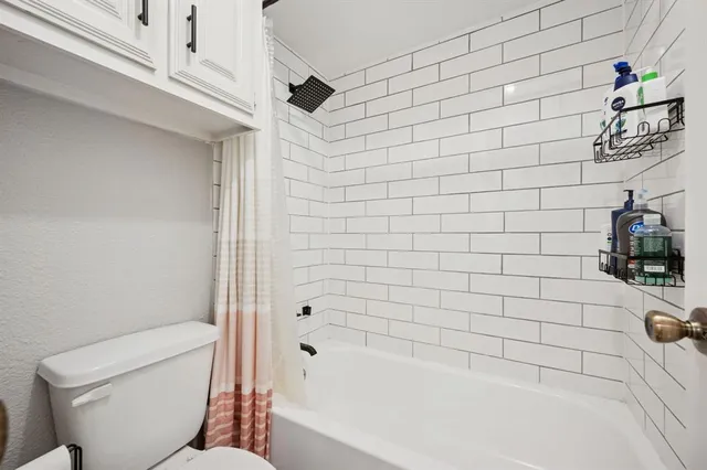 a bathroom with a bathtub and a toilet