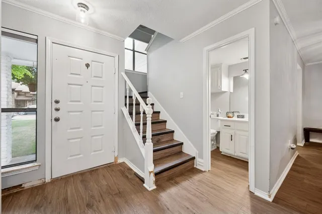 a view of a hallway with wooden floor and entryway