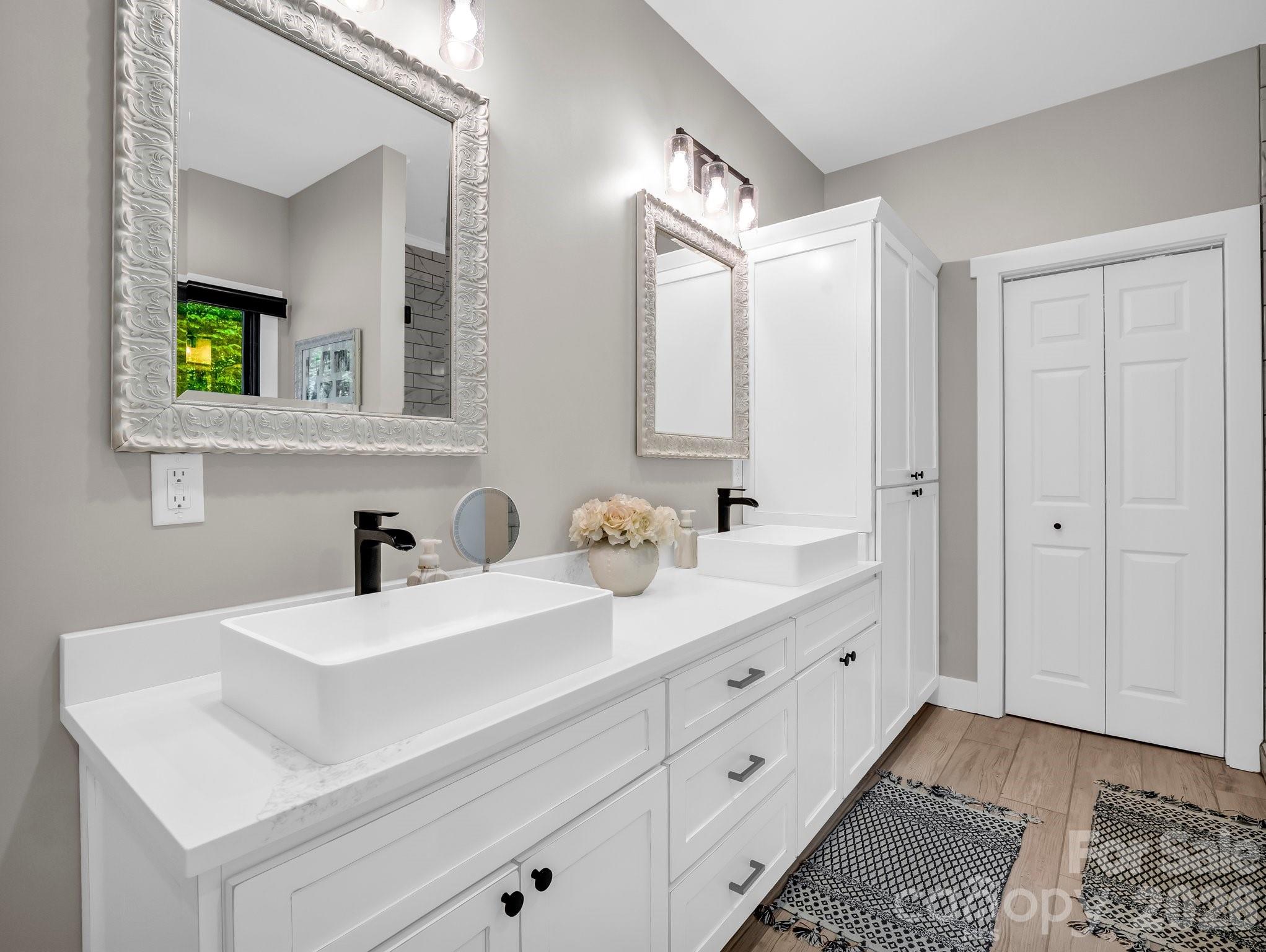 5717 Turnpike Road Horse Shoe, NC 28742 - Photo 17 of 36 a bathroom with double sink and a mirror