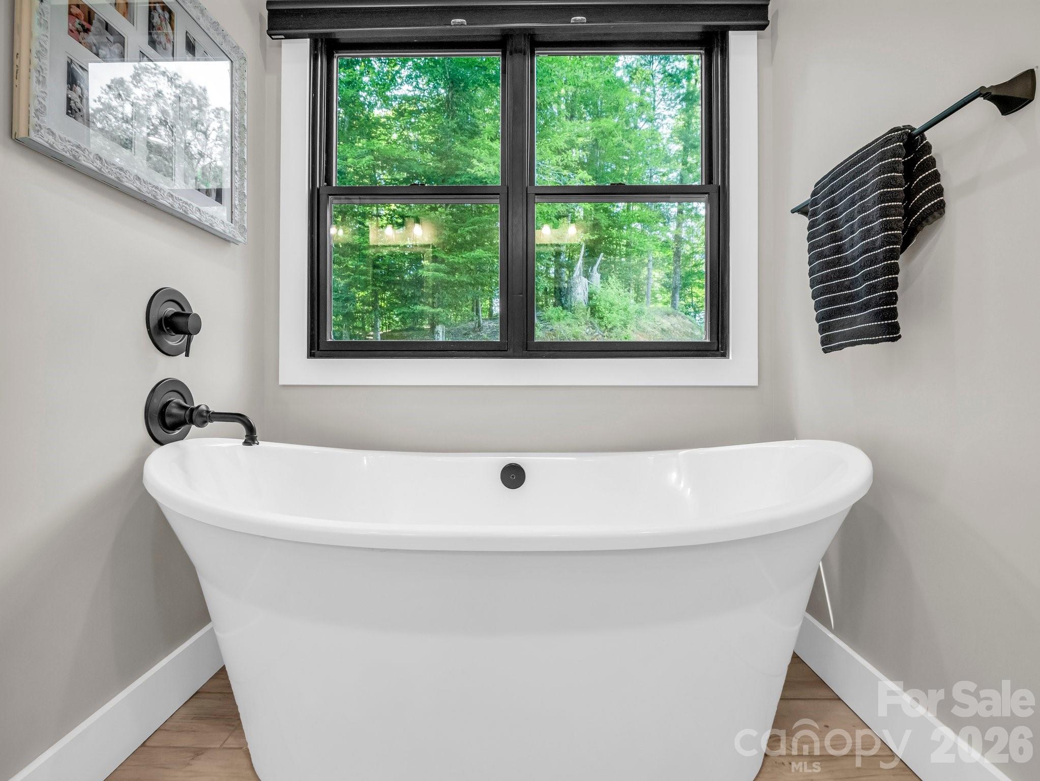 5717 Turnpike Road Horse Shoe, NC 28742 - Photo 19 of 36 a white bath tub sitting in a bathroom