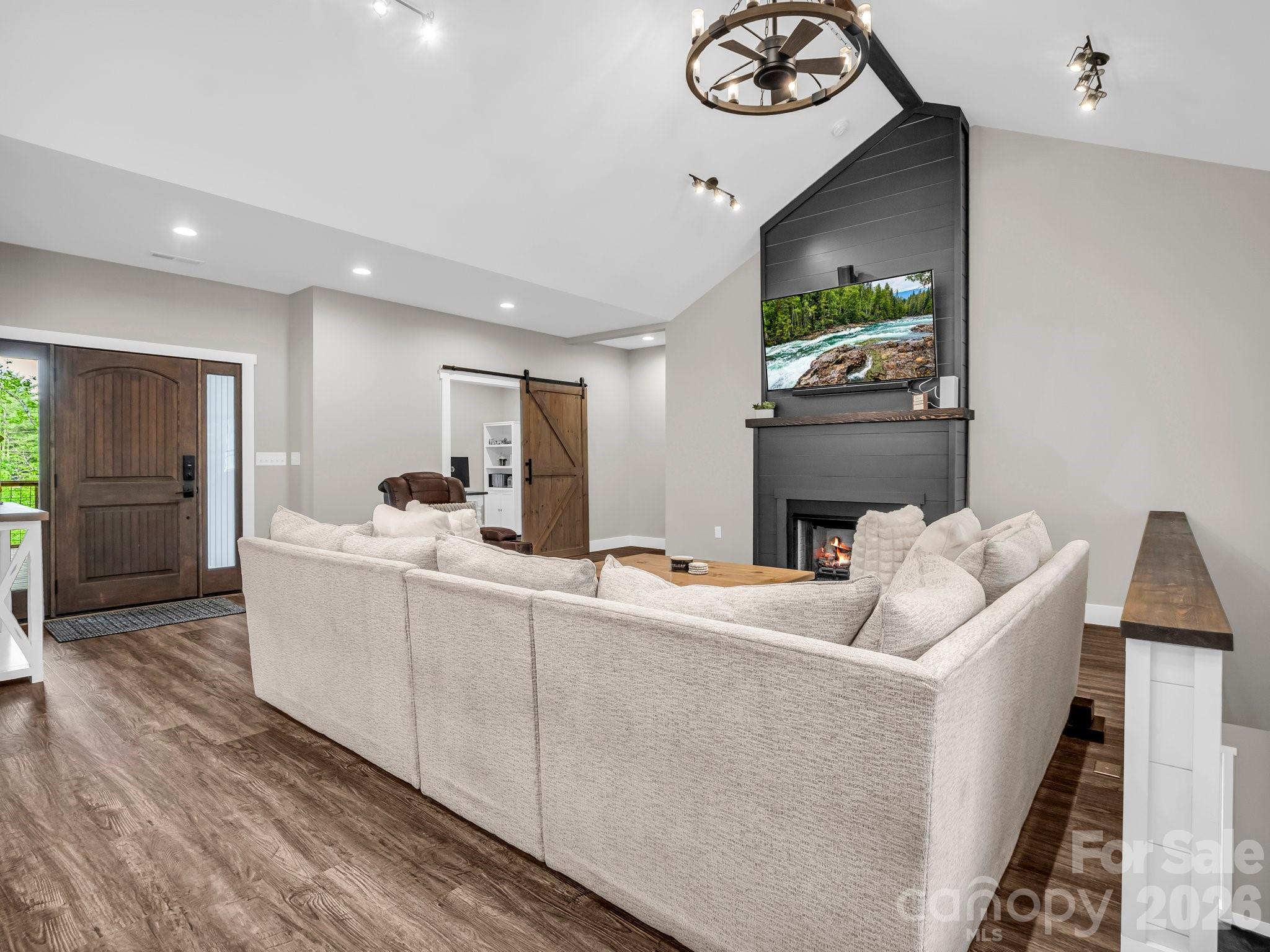 5717 Turnpike Road Horse Shoe, NC 28742 - Photo 29 of 36 a living room with furniture and a flat screen tv