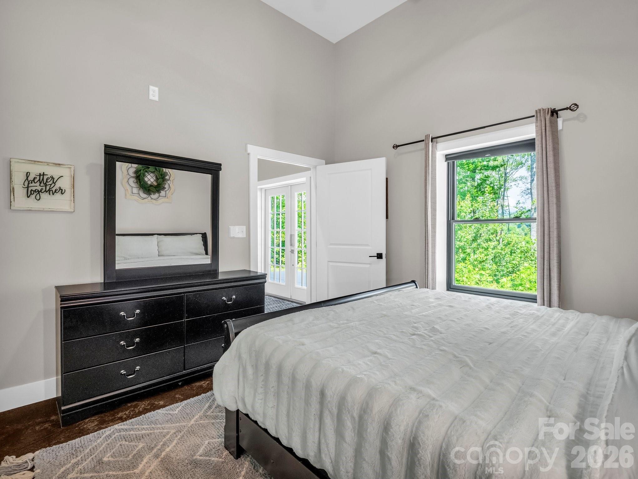 5717 Turnpike Road Horse Shoe, NC 28742 - Photo 6 of 36 a bedroom with a bed window and wall painting