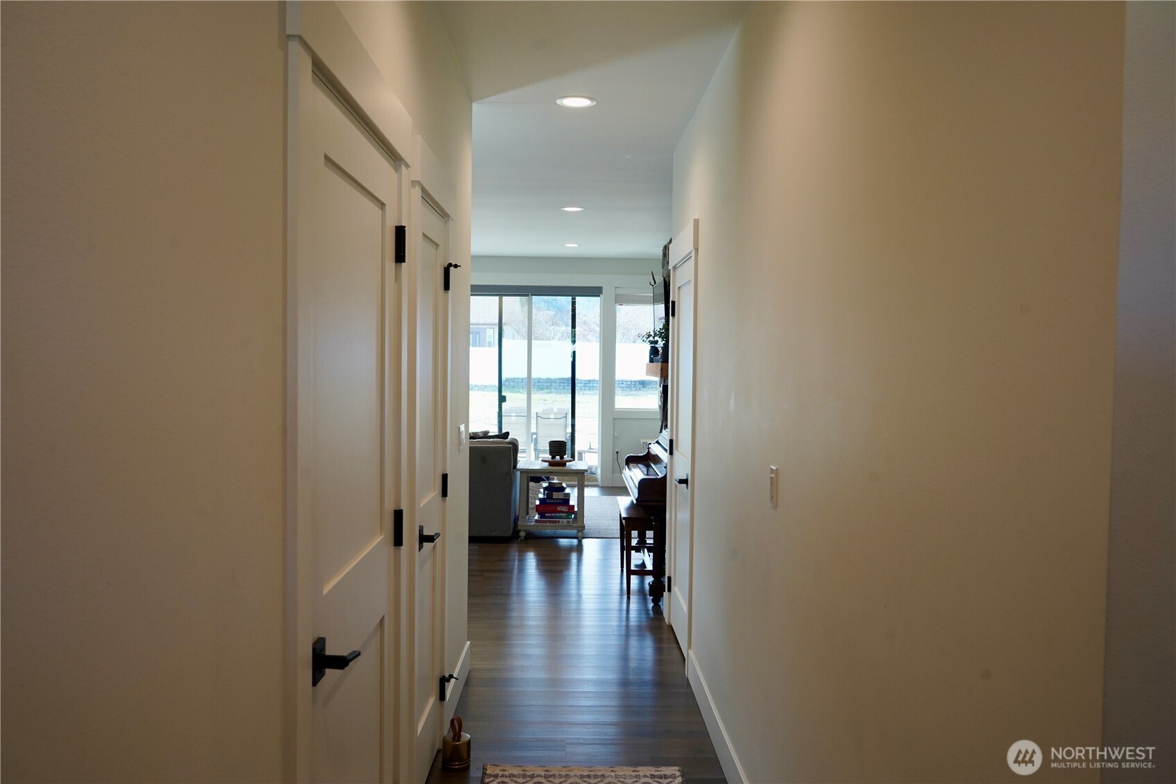 104 Freedom Hills Cashmere, WA 98815 - Photo 6 of 40 a view of a hallway with living room and couches with wooden floor