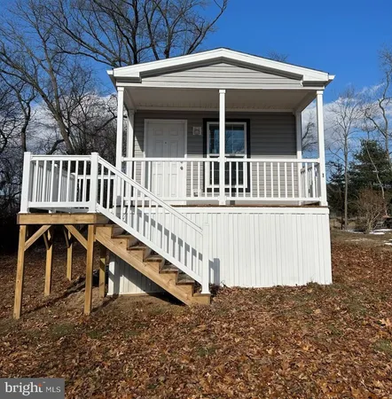 a view of a house with wooden fence