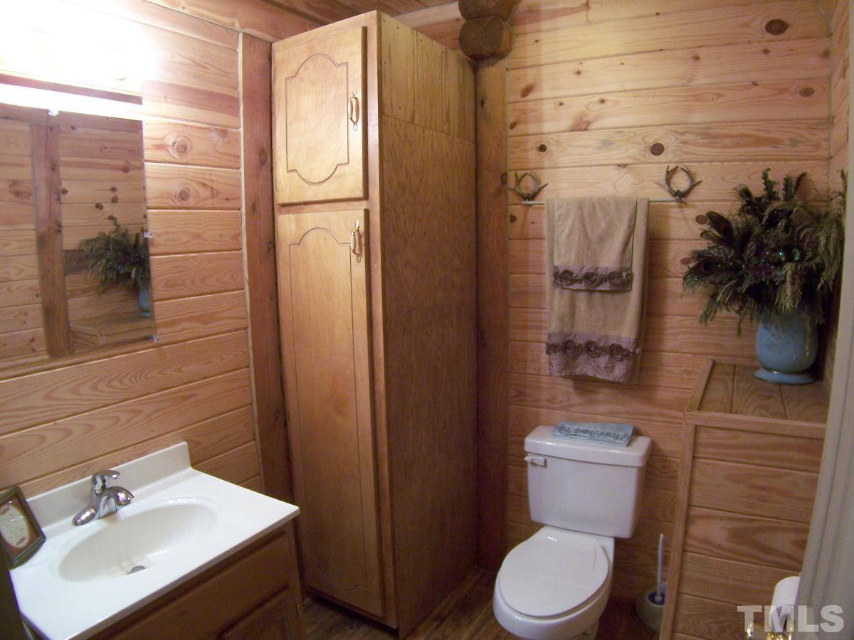 239 Rocky Ridge Road Leasburg, NC 27291 - Photo 17 of 23 a white toilet sitting next to a bathroom sink