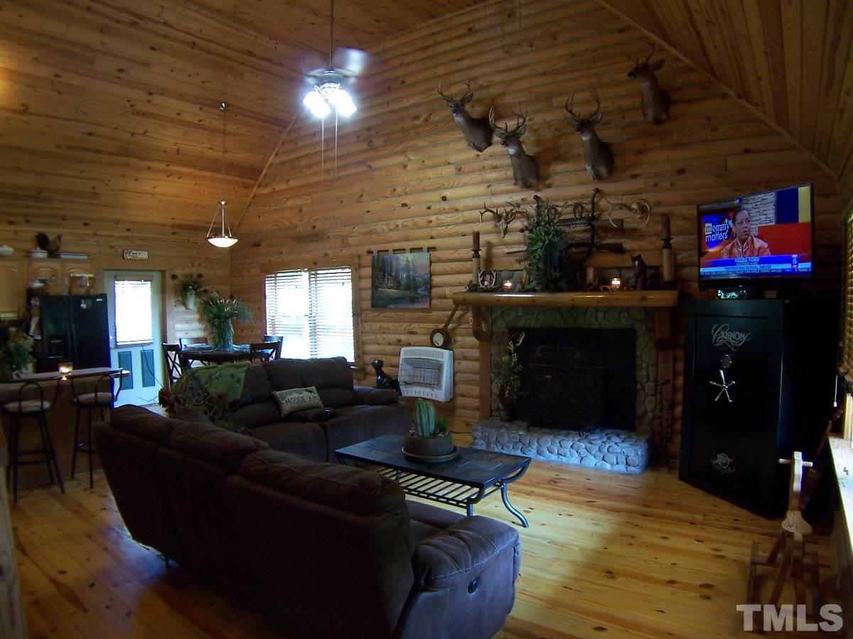 239 Rocky Ridge Road Leasburg, NC 27291 - Photo 4 of 23 a living room with furniture and a fireplace