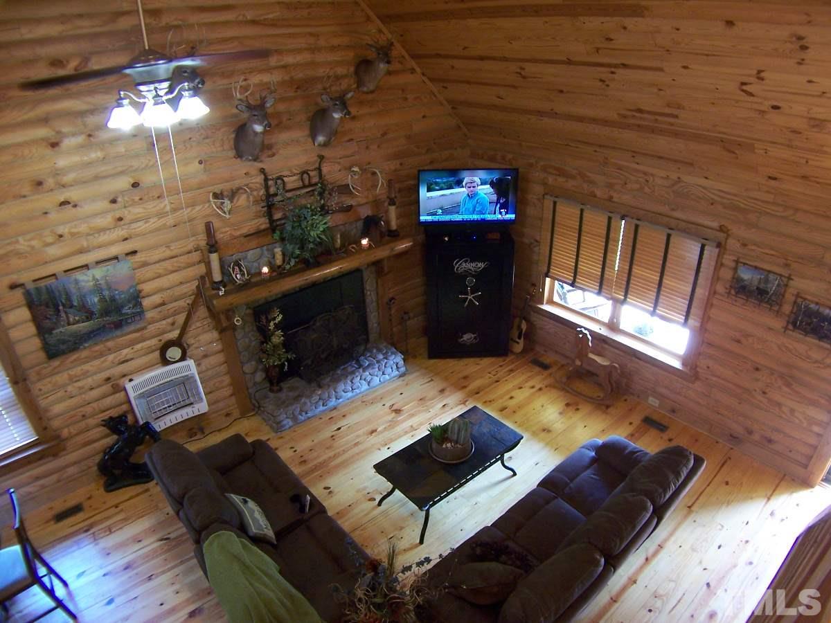 239 Rocky Ridge Road Leasburg, NC 27291 - Photo 10 of 23 a living room with furniture and a fireplace