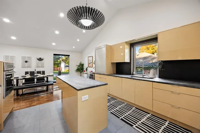 a living room with furniture a rug and a table