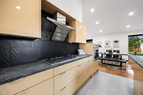 a kitchen with stainless steel appliances granite countertop a sink and a stove top oven