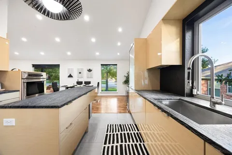 a kitchen with stove and cabinets