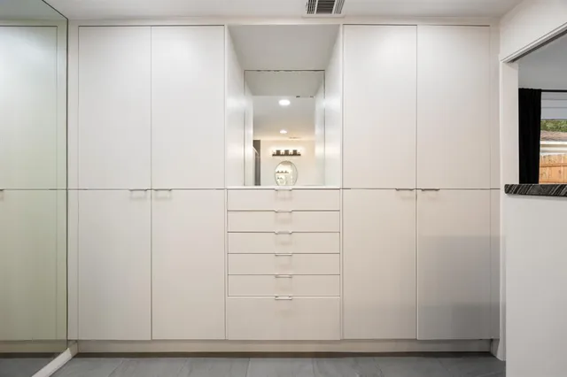 a bathroom with a granite countertop sink mirror and vanity