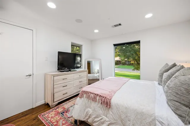 a bedroom with a bed and a dresser