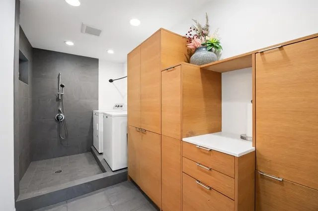 a view of a workspace with furniture and a table in it