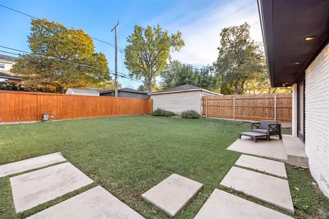 a view of a patio with a table and chairs