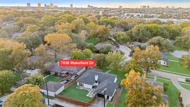 a view of a house with a backyard and a patio