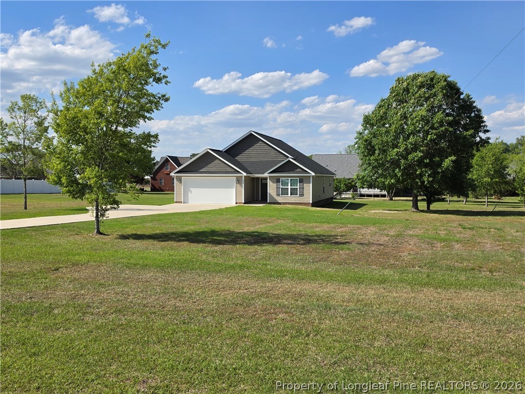 422 Mitchell Farm Road Goldsboro, NC 27530 - Photo 5 of 28 a view of green field with tree in the background