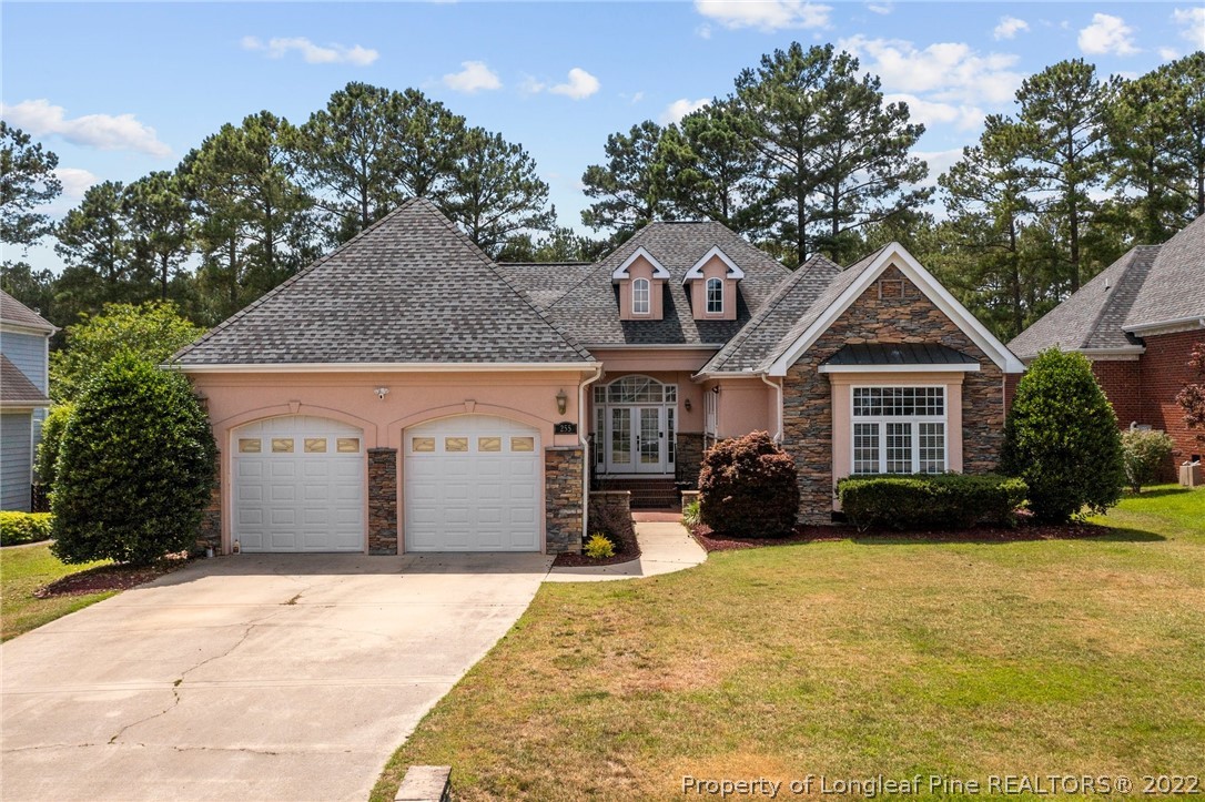 255 Falling Water Road Spring Lake, NC 28390 - Photo 1 of 39 a front view of a house with a yard and garage