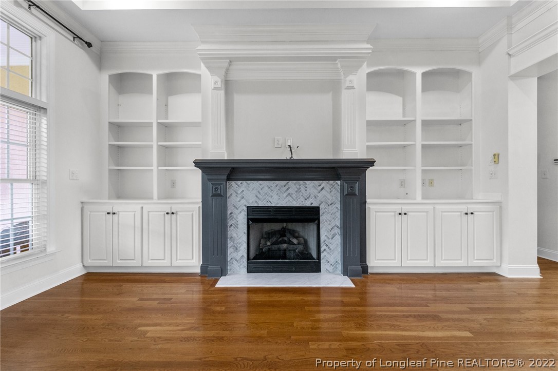 255 Falling Water Road Spring Lake, NC 28390 - Photo 15 of 39 a living room with a fireplace cabinet and a fireplace