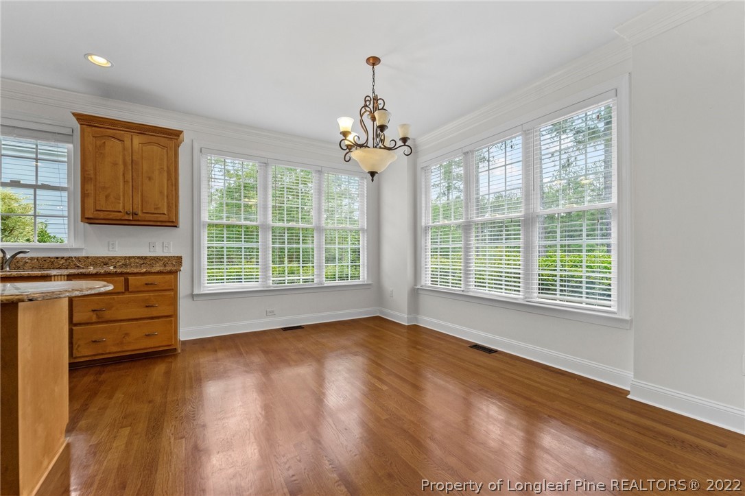 255 Falling Water Road Spring Lake, NC 28390 - Photo 16 of 39 a view of an empty room with a window and wooden floor