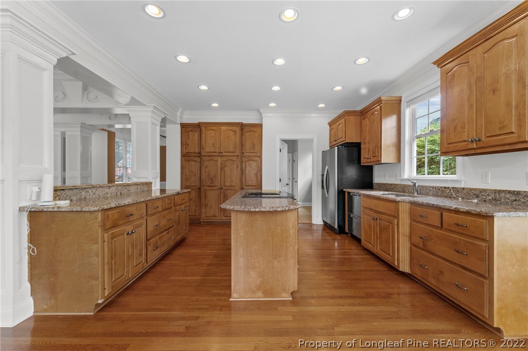 255 Falling Water Road Spring Lake, NC 28390 - Photo 17 of 39 a large kitchen with stainless steel appliances kitchen island granite countertop a large counter top and stainless steel appliances