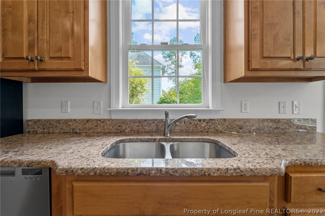 255 Falling Water Road Spring Lake, NC 28390 - Photo 20 of 39 a kitchen with granite countertop a sink and cabinets