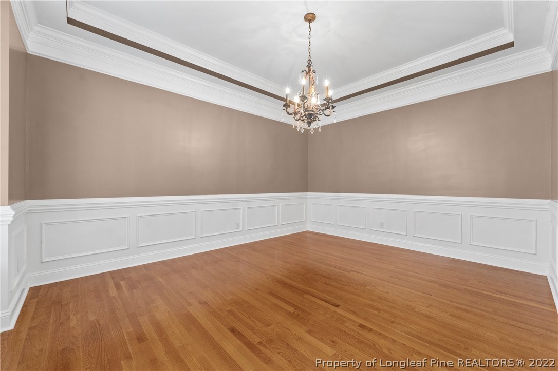255 Falling Water Road Spring Lake, NC 28390 - Photo 22 of 39 a view of an empty room with wooden floor and a window