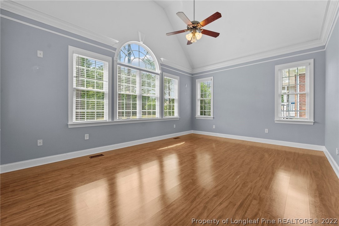 255 Falling Water Road Spring Lake, NC 28390 - Photo 26 of 39 a view of an empty room with a window and wooden floor