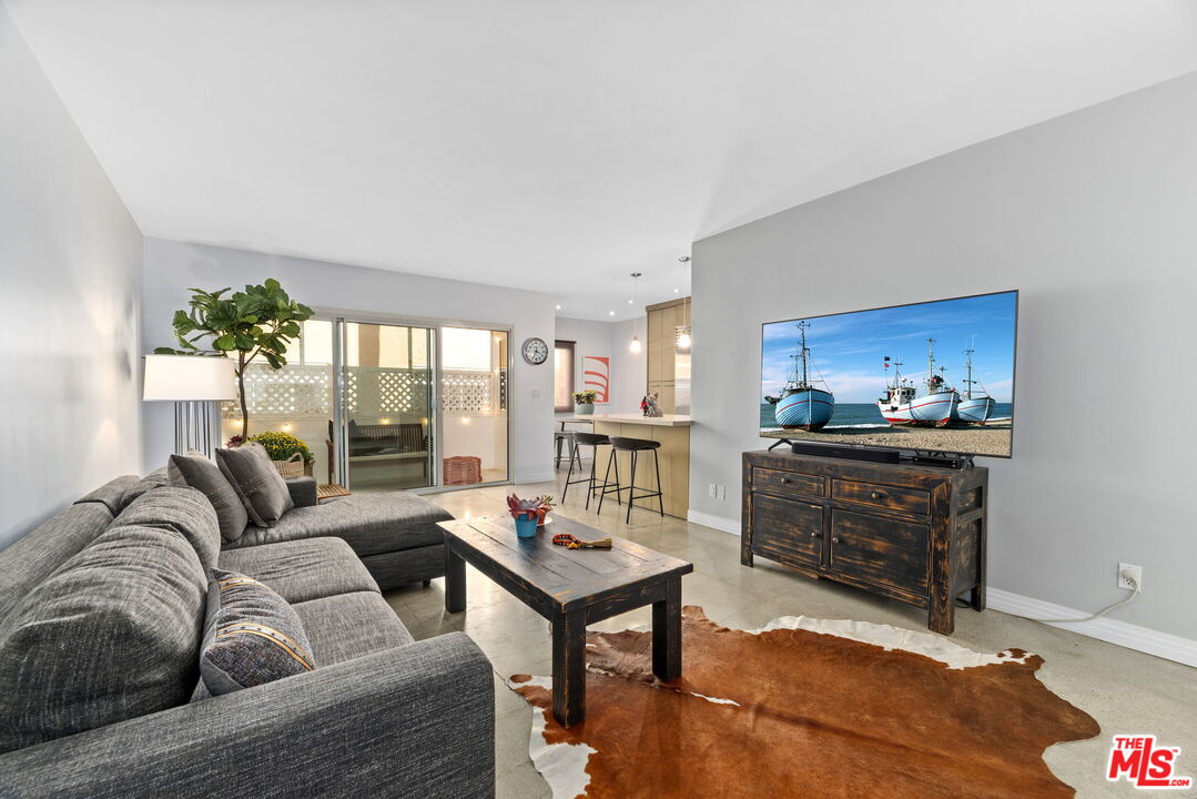 8710 Delgany Avenue, Unit 3 Playa del Rey, CA 90293 - Photo 2 of 21 a living room with furniture and a fireplace