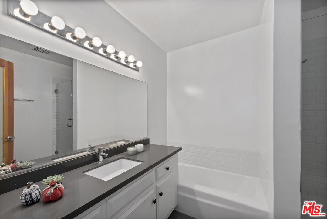 8710 Delgany Avenue, Unit 3 Playa del Rey, CA 90293 - Photo 16 of 21 a bathroom with a tub sink and mirror