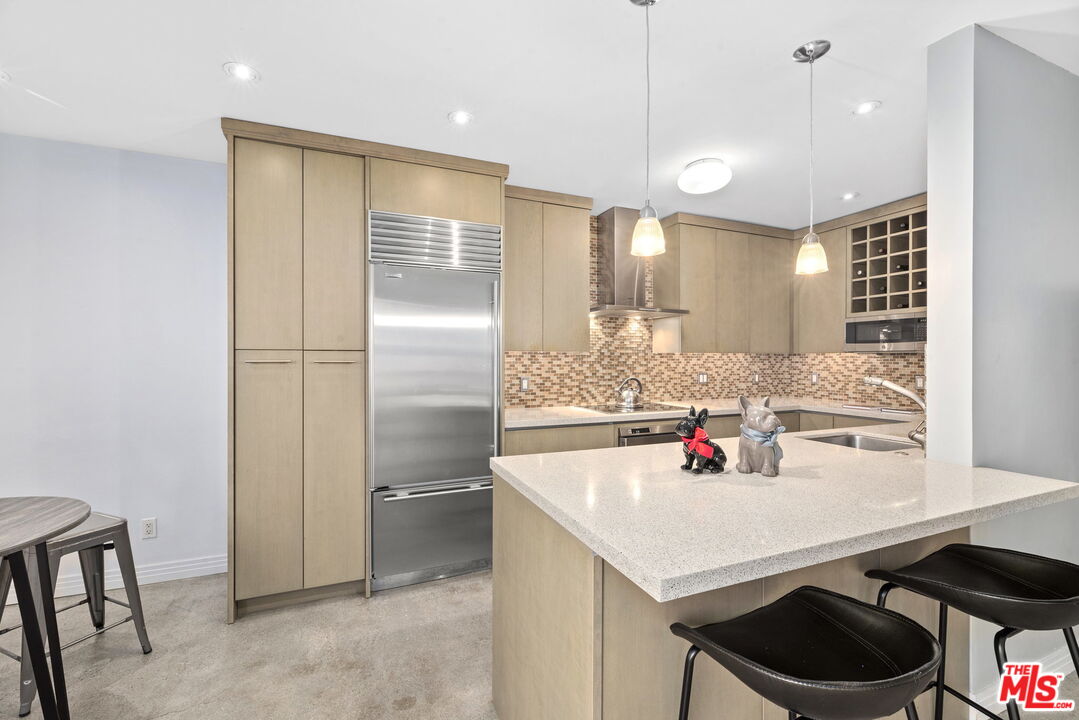8710 Delgany Avenue, Unit 3 Playa del Rey, CA 90293 - Photo 8 of 21 a kitchen with a sink a refrigerator and chairs