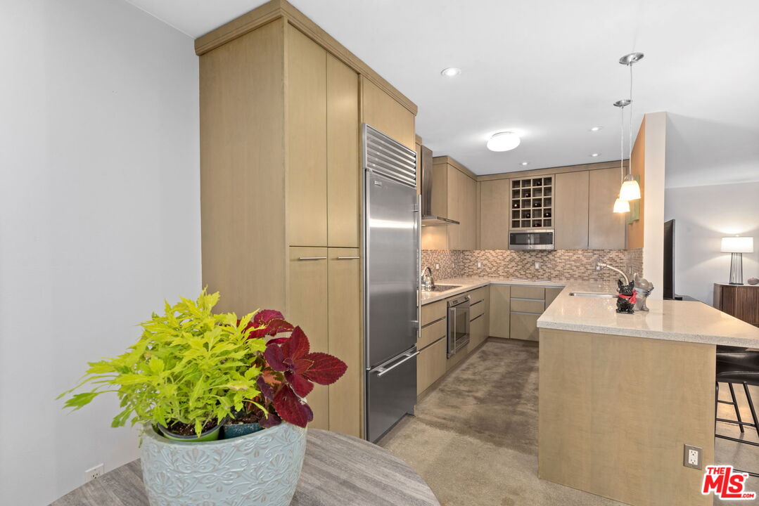 8710 Delgany Avenue, Unit 3 Playa del Rey, CA 90293 - Photo 9 of 21 a kitchen with stainless steel appliances a sink and a refrigerator