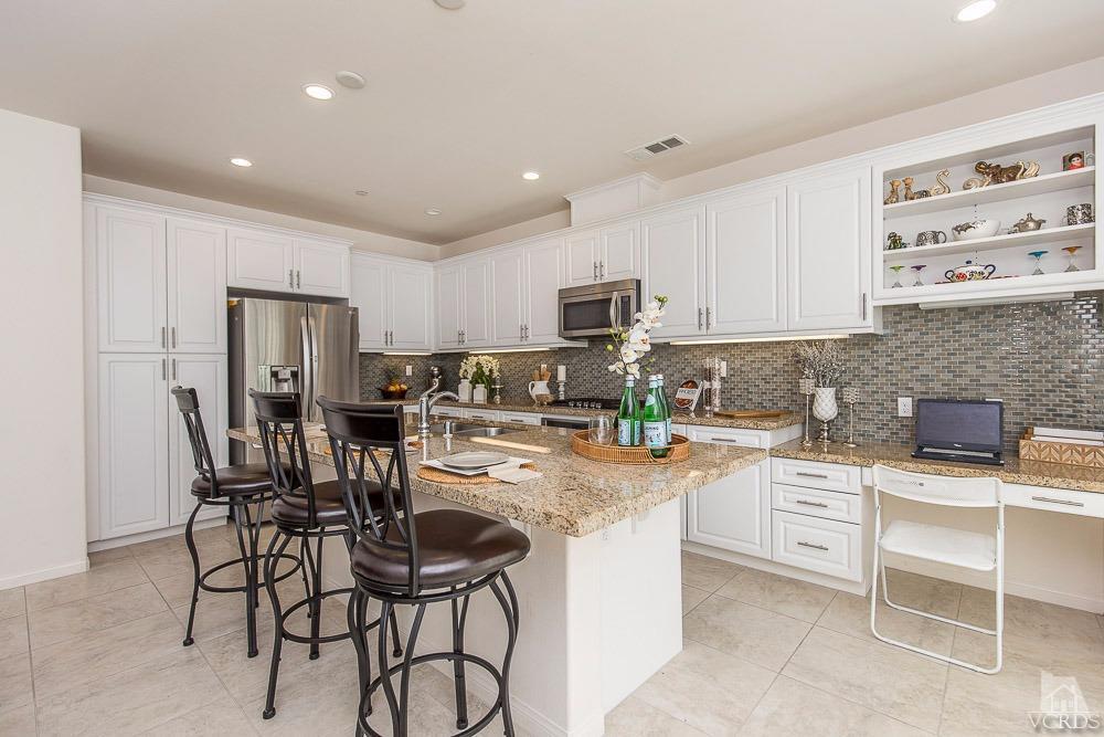 4885 Edenbridge Road Moorpark, CA 93021 - Photo 13 of 30 a kitchen with cabinets a sink a counter space stainless steel appliances and cabinets