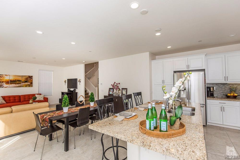 4885 Edenbridge Road Moorpark, CA 93021 - Photo 14 of 30 a kitchen with a dining table cabinets and stainless steel appliances