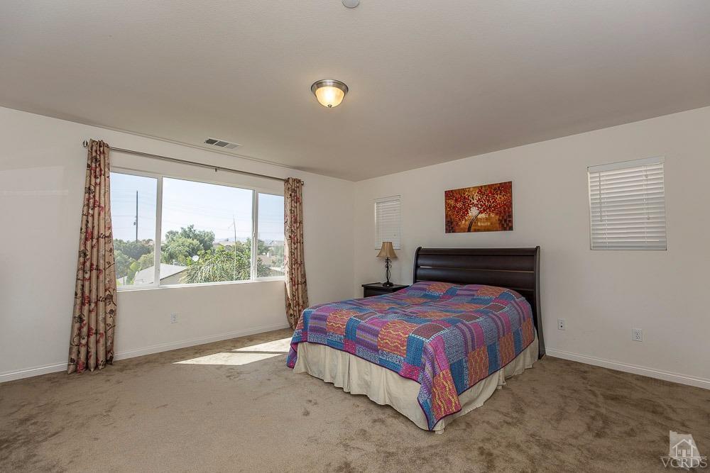 4885 Edenbridge Road Moorpark, CA 93021 - Photo 23 of 30 a bedroom with a bed and a window