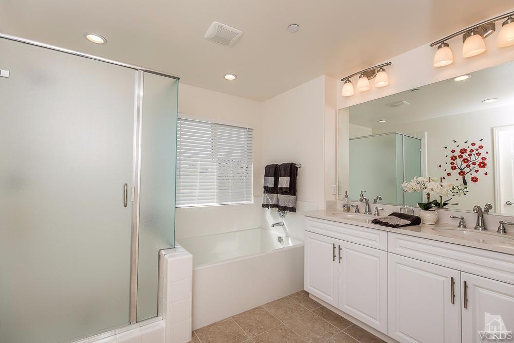 4885 Edenbridge Road Moorpark, CA 93021 - Photo 24 of 30 a bathroom with a bathtub a double vanity sink and mirror