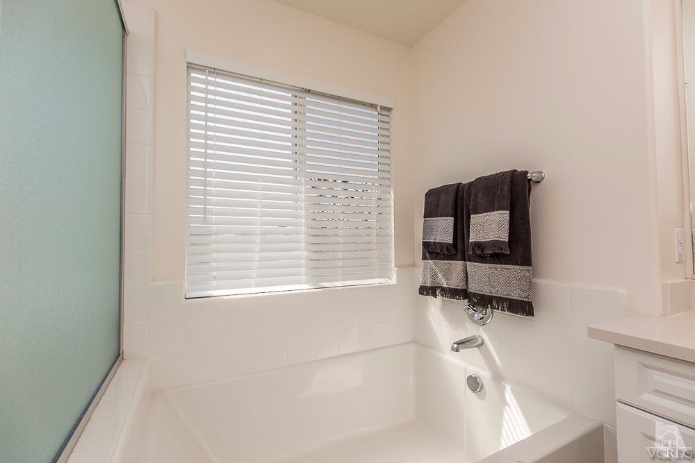 4885 Edenbridge Road Moorpark, CA 93021 - Photo 25 of 30 a bathroom with a bathtub sink and window