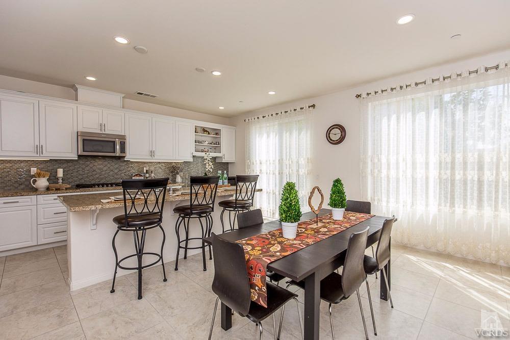 4885 Edenbridge Road Moorpark, CA 93021 - Photo 10 of 30 a view of a dining room with furniture and chandelier