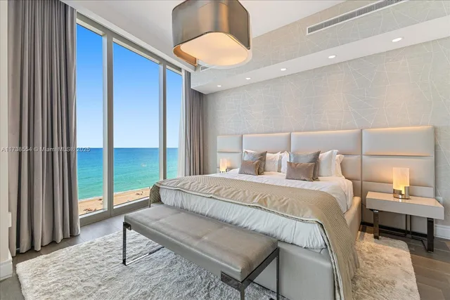 a bedroom with a bed and a large window