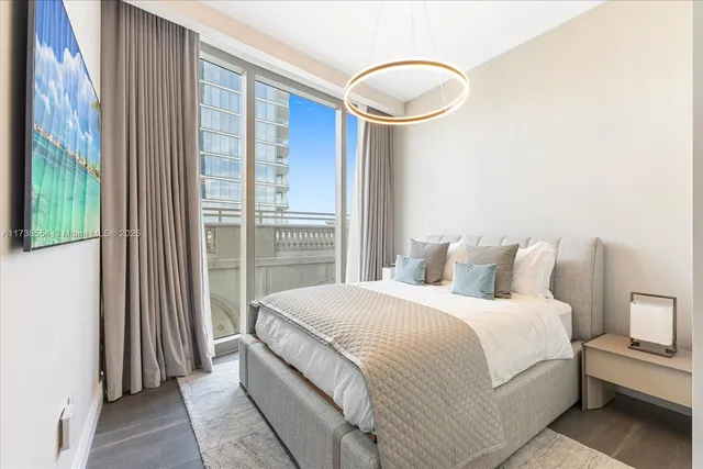 a bedroom with a large bed and a large window