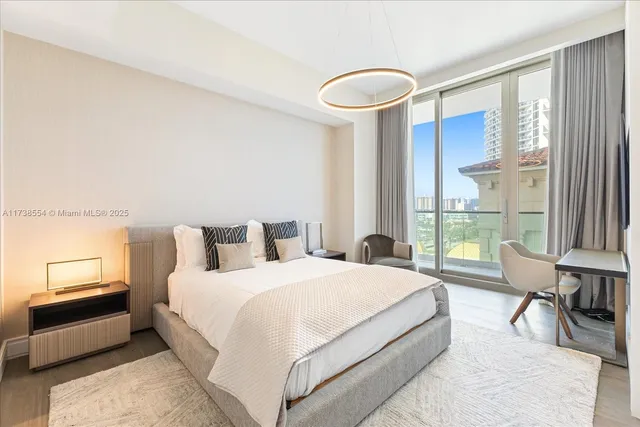 a spacious bedroom with a bed and a large window